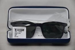 A pair of as new Lacoste sunglasses.