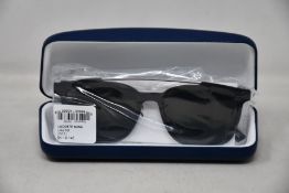 A pair of as new Lacoste sunglasses.