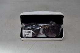 A pair of as new Calvin Klein sunglasses.