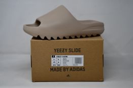 A pair of as new Adidas Yeezy Slide (UK 9).