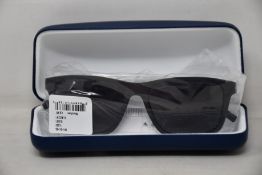 A pair of as new Lacoste sunglasses.