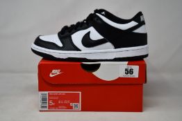 A pair of youths as new Nike Dunk Low GS (UK 4.5).