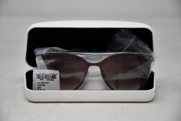 A pair of as new Calvin Klein sunglasses.