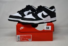 A pair of youths as new Nike Dunk Low GS (UK 4).