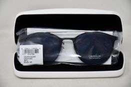 A pair of as new Calvin Klein sunglasses.