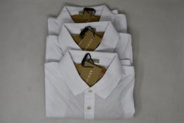 Three as new Burberry polo shirts in white (XL).
