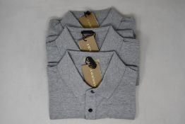 Three as new Burberry polo shirts in grey (S).