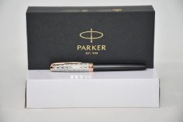 A boxed as new Parker Sonnet Premium metal and grey rollerball pen.