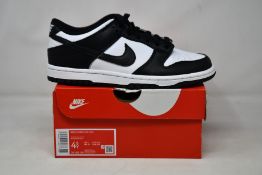 A pair of youths as new Nike Dunk Low GS (UK 4).