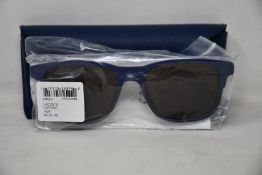 A pair of as new Lacoste sunglasses.