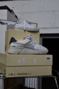 A pair of as new Axel Arigato Genesis Triple sneakers (UK 7) together with a pair of children's Axel