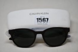 A pair of as new Calvin Klein sunglasses.