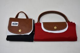Two as new Longchamps foldable tote bags.