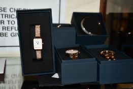 Three assorted as new Daniel Wellington watches together with two bangles.