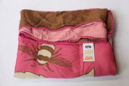 An as new Karen Mabon X Peter Rabbit woven raspberry blanket, part of a limited-edition capsule