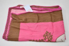 An as new Karen Mabon X Peter Rabbit woven raspberry blanket, part of a limited-edition capsule
