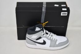 A pair of as new Nike Air Jordan 1 Mid (UK 9).