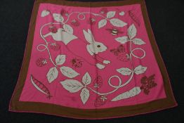 An as new Karen Mabon X Peter Rabbit woven raspberry blanket, part of a limited-edition capsule