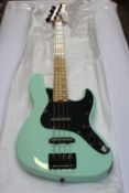 A boxed as new Schecter J-4 Jazz Bass in Seafoam Green.
