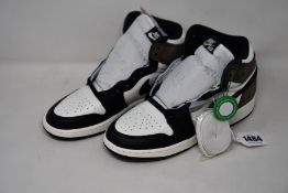 A pair of youths as new Nike Air Jordan 1 Retro High OG GS dark mocha with authentication tag (UK