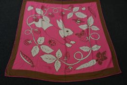 An as new Karen Mabon X Peter Rabbit woven raspberry blanket, part of a limited-edition capsule