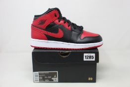 A pair of youths as new Nike Air Jordan 1 Mid (UK 6).