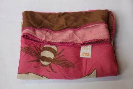 An as new Karen Mabon X Peter Rabbit woven raspberry blanket, part of a limited-edition capsule