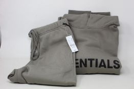 An as new Essentials Fear of God hoodie in cement with matching sweatpants, both with authentication