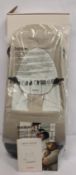 A Babybjorn Bouncer Balance Soft in beige and grey.