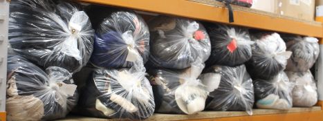 Twelve bags of pre-owned clothing and related items.