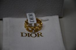 An as new Dior Danseuse Etoile ring in gold finish metal (Size X - RRP £290).