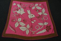 An as new Karen Mabon X Peter Rabbit woven raspberry blanket, part of a limited-edition capsule