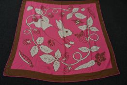 An as new Karen Mabon X Peter Rabbit woven raspberry blanket, part of a limited-edition capsule