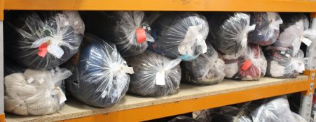 Twelve bags of pre-owned clothing and related items.