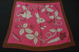 An as new Karen Mabon X Peter Rabbit woven raspberry blanket, part of a limited-edition capsule