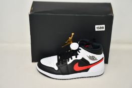 A pair of as new Nike Air Jordan 1 Mid with authentication tag (UK 8.5).