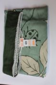 An as new Karen Mabon X Peter Rabbit woven green blanket, part of a limited-edition capsule