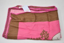 An as new Karen Mabon X Peter Rabbit woven raspberry blanket, part of a limited-edition capsule