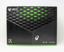 A boxed as new Xbox Series X 1TB games console in black (box opened - inner packaging sealed).