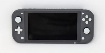 A refurbished Nintendo Switch Lite games console in grey with UK charger and DC super villains
