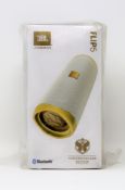 A boxed as new JBL Flip 5 Tomorrowland Edition Portable Bluetooth Speaker (Packaging sealed).