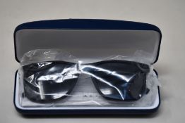 A pair of as new Lacoste sunglasses.