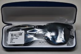 A pair of as new Lacoste sunglasses.