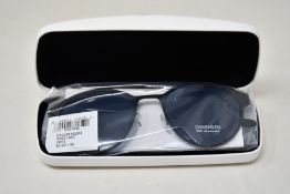 A pair of as new Calvin Klein sunglasses.
