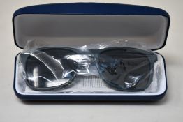 A pair of as new Lacoste sunglasses.