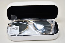 A pair of as new Calvin Klein sunglasses.
