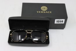 A pair of as new Versace Havana sunglasses.