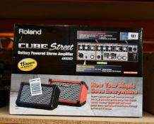 A Roland CUBE Street Battery Powered Stereo Amplifier in black.