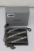 An as new Balenciaga coated canvas printed bi-fold logo chain wallet.