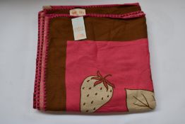An as new Karen Mabon X Peter Rabbit woven raspberry blanket, part of a limited-edition capsule